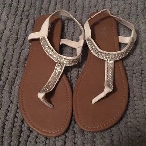 Simple White sandals with silver detailing.